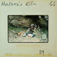 Old photograph of a pile of rocks with grass and dirt, labeled "Matson's Kiln" on the negative strip.