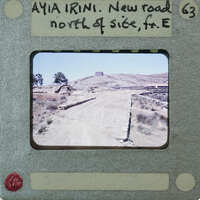 A film strip with a photograph of a dirt road and rocky terrain.