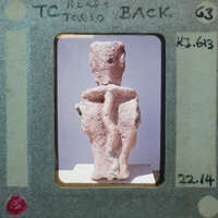 Terracotta figurine fragment (K3.613) from back showing head and torso.