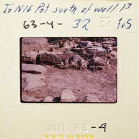 Photo of an archaeological site with ruins and stones.