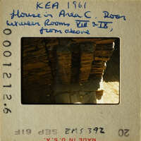 Old photograph with handwritten notes on a vintage film strip card, featuring an image of a stone structure.