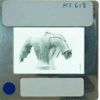 Terracotta figurine torso from back.