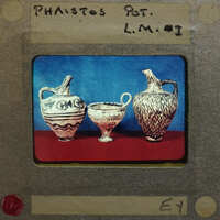 Three small jugs in profile showing intricate painted designs.