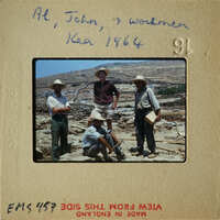 Four men posing with a mountainous landscape behind them, circa 1964.