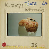 Ancient Greek vase with figures on display.