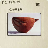 Ancient clay pot with visible cracks and chips, displayed on a white surface.