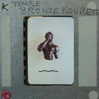 A bronze sculpture of a man with his hand over his mouth, displayed on a card.