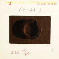 Old photograph of a rusted metal object, possibly a key or lock mechanism.