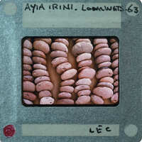 Stacked circular lentoid clay objects upright.