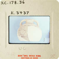 Ancient vase with visible cracks and missing pieces on a blue background.