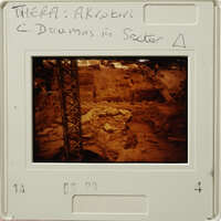 Archaeological site with ruins and scaffolding, as seen on an old slide.