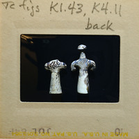Two small reconstructed figurines showing dark paint on white surface, K1.43, K4.11.