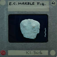 Marble figurine torso fragment.