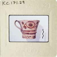 A ceramic mug with an eye design on its side.