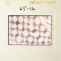 This is an image of a microscopic view of a diamond pattern of white on red-brown background.