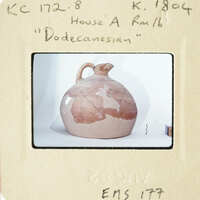 Ancient Greek vase with map-like design on display.