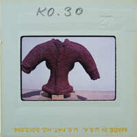 A red sculpture of a humanoid figure on display.