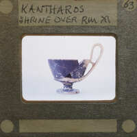 Reassembled katharos style cup with large handle in profile.