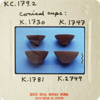 Four small brown cups on blue surface.