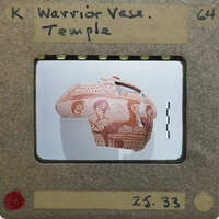 Partially reassembled vase with warrior motif in red paint.