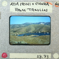 A photograph of a scenic landscape with mountains and a lake, taken from Chora on Ikaria Island.
