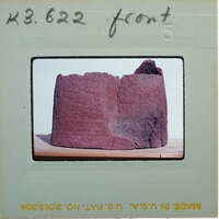 Broken base of terracotta figurine skirt from front.