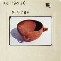 Ancient Greek pottery with visible cracks and wear, photographed on a white surface.