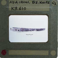 Two images of a knife, with the top image showing the blade and handle, and the bottom image providing a close-up view of the blade's edge.