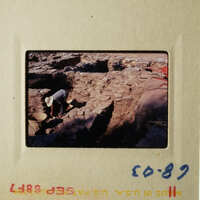 Archeological site with two people working on excavation.