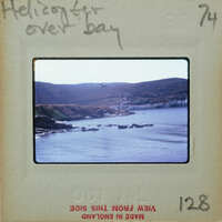 A body of water with mountains in the background.