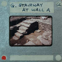 Old photo of a stone staircase with handwritten label on the border.