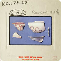 Ancient pottery fragments displayed on a blue background with white lines and labels.