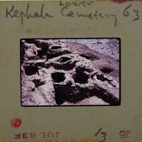 Ancient ruins with holes and a stone structure.