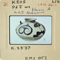 Ancient Greek vase with intricate black and white designs.