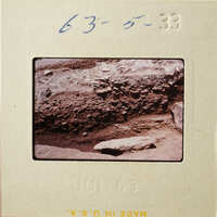 A photograph of an outdoor scene with rocks and dirt, taken on July 6, 1963.