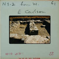 This is a photograph of an archaeological site with exposed stone ruins, possibly from ancient times.