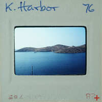 Picture of water with island and boat, taken from a high vantage point.