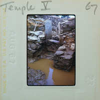 Old stone ruins with a muddy water feature.