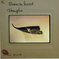 A photograph of a bronze boat on display, with the name "Bronze Boat" written above it.