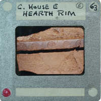 A close-up photo of a rusted metal object with an attached label.