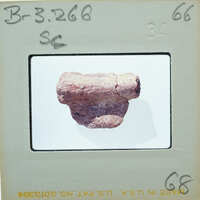 A photograph of a rock specimen on a white background, with an information card and label.