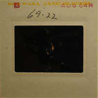 Old photograph with a yellowed frame and a red stamp on the top left corner.