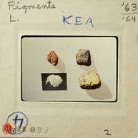 Photograph of four samples with labels, possibly minerals or substances on display.