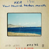 View towards harbor mouth with blue ocean and distant land.