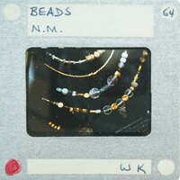 A close-up photo of a necklace with beads.