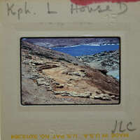 A photograph of a rugged coastline with rock formations and the sea.