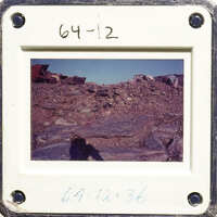 Old photograph with date stamp, showing rocky landscape.