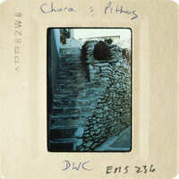 A photograph of stone steps with a rustic wall, taken from an elevated perspective.