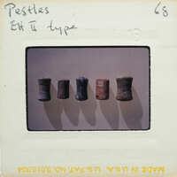 A collection of five cylindrical objects with different colors and textures, displayed on a white surface.