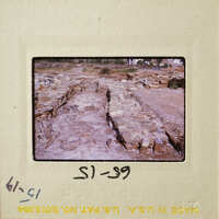 Old ruins with stone columns and walls, possibly part of an ancient city or temple.